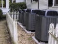 Four Trane Premium Heat Pumps Installed Outside a Home.JPG